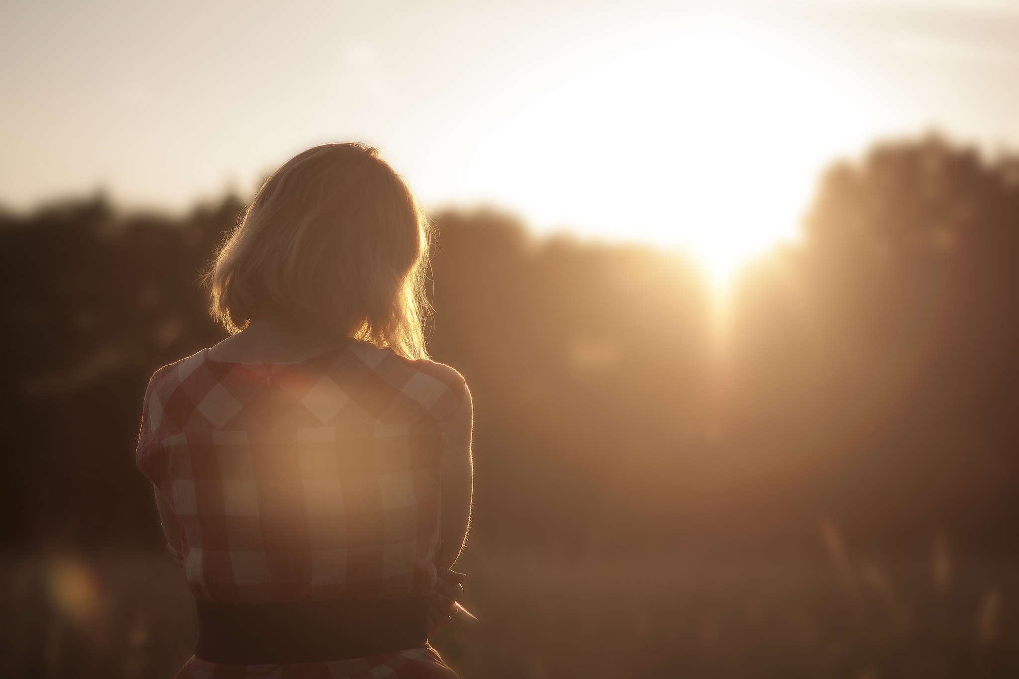 women looking at a sunset in a field