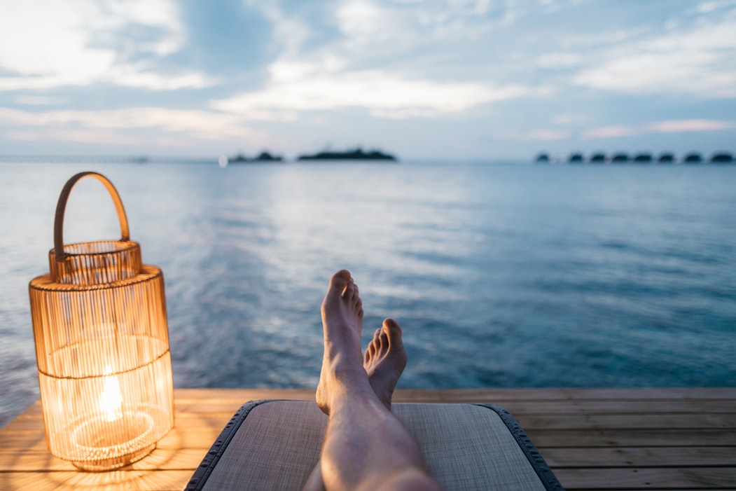 Person sitting on chair on dock