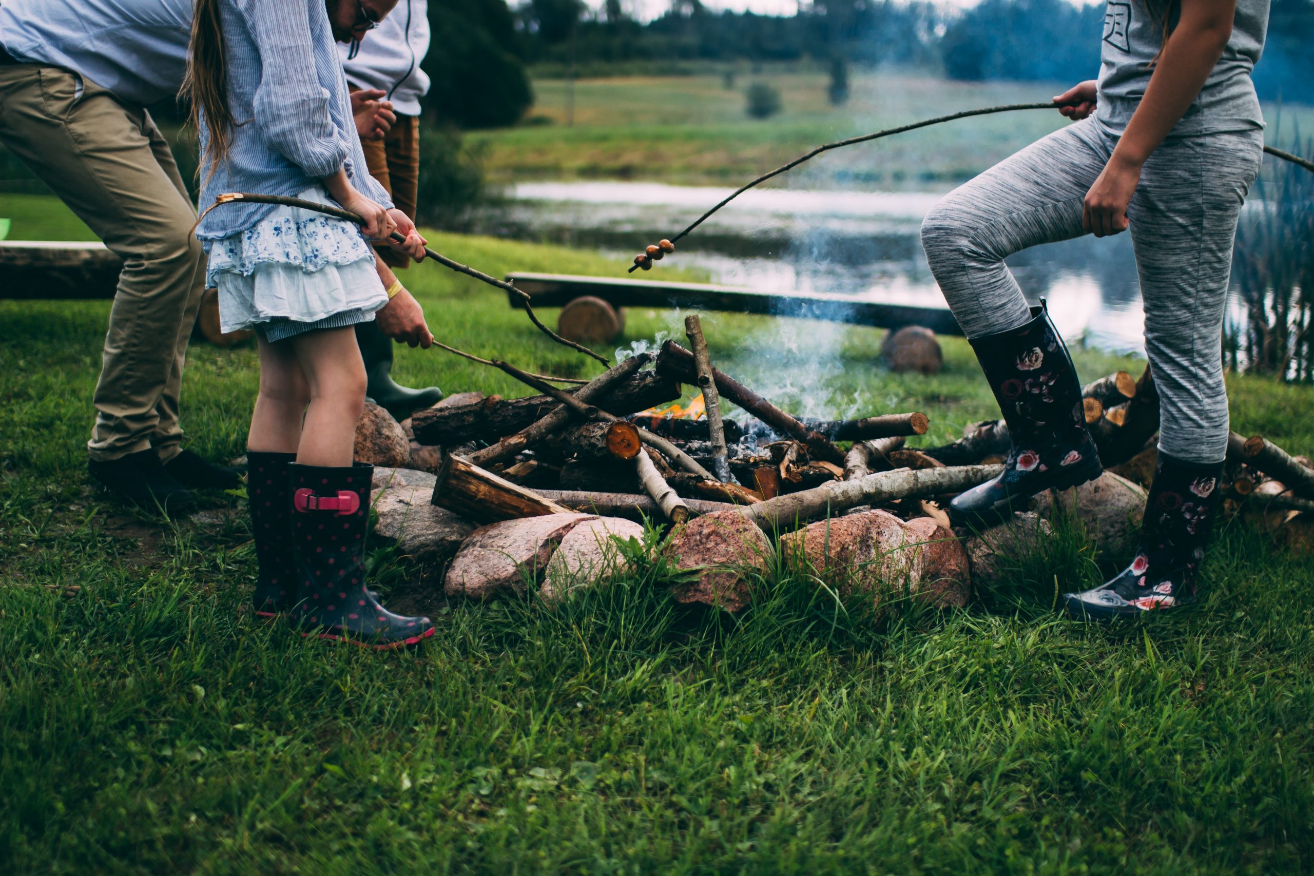 family around fire on camping trip